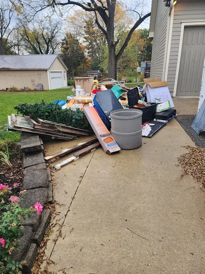 Dumpster being loaded with debris for 3 Yard Dumpster Rental in McAllen